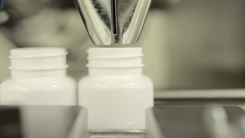 Automatic Capsule Counting and Bottling Machine in Pharmaceutical Production Stock Footage 333159925
