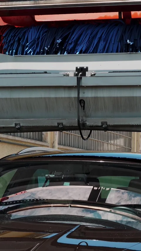 Automatic car drying. Blue and Red Brushes Cleaning a Vehicle Stock-Footage 313732298