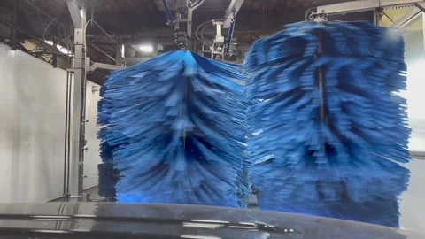 Automatic car wash in action - colorful foam, soft bruches - view from the front Stock Footage 249145755