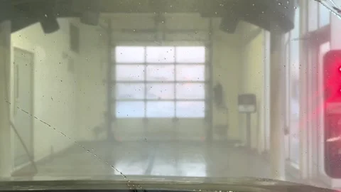 Automatic car wash from inside the car. Dashboard view inside of car in carwash. Stock Footage 256729906
