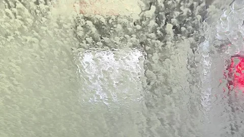 Automatic car wash from inside the car. Dashboard view inside of car in carwash. Stock Footage 256729927