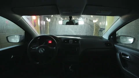 Automatic car wash. From the inside. Roller soaping and scrubbing the windshield Видео 46994490