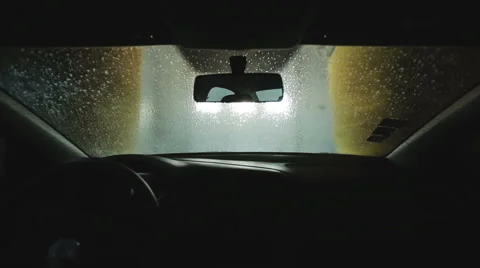 Automatic car wash. From the inside. Roller soaping and scrubbing the windshield Stock Footage