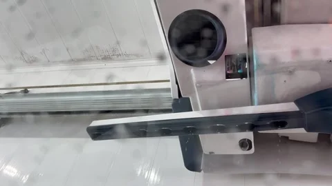 Automatic car wash mechanical arm operating inside a wash bay Stock Footage 340527367