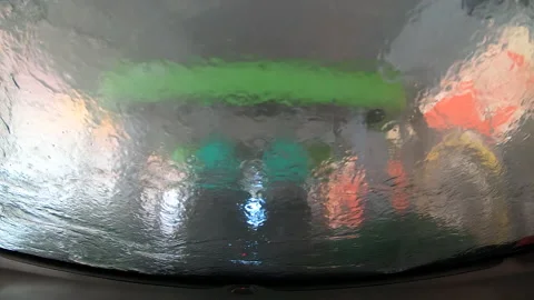 Automatic car wash process in the car wash tunnel. Brushes washing the car Video stock 135411926