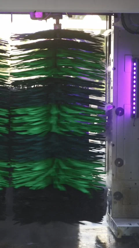 Automatic car wash in process - large brushes wash the machine Stock Footage 329547298