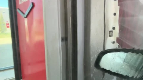 Automatic Car Wash with Red Brushes and Cleaning Spray Stock Footage 333050975