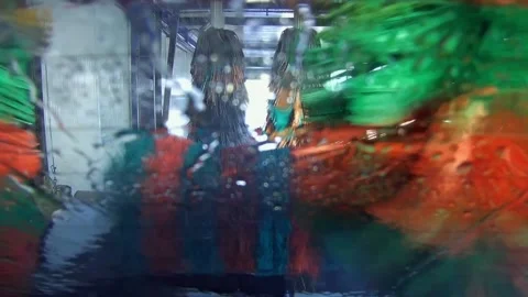 Automatic car wash as seen from back of vehicle moving through machine Stockbeeldmateriaal 228599725