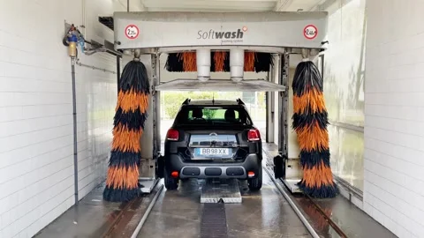 Automatic Car Wash Tunnel With Brushes Cleaning Car, Handheld Shot Stock Footage 339573147