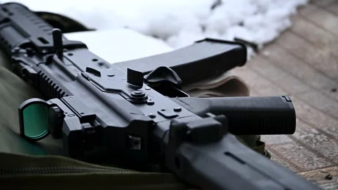 Automatic - the carbine lies on the table next to the casings Stock Footage