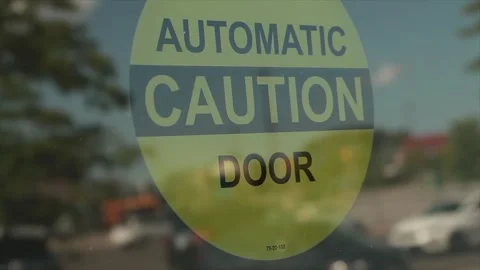 Automatic caution door symbol on glass automatic door in circle, with cars Stock Footage 249098589
