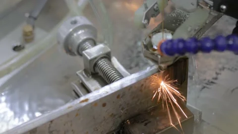 Automatic cnc wire cutting machine working with metal workpiece with sparks Stock Footage 136758659