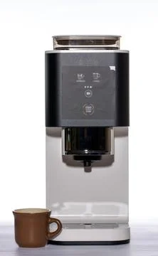Automatic coffee machine with a cup on a white background Stock Photos