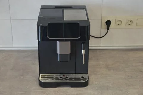 Automatic coffee machine on a gray kitchen countertop. Home appliances. Fotos Stock