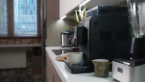 Automatic coffee machine makes a cup of morning coffee Stock Footage 165303912