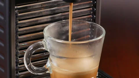 Automatic coffee machine making italian espresso coffee in glass video closeu Stock Footage 145604199