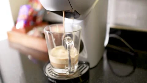 Automatic Coffee Machine Pouring Fresh Espresso Into a Clear Glass Mug Stock Footage 334984829