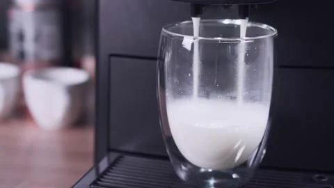 Automatic coffee machine prepares milk froth for the latte. Stock Footage 161163165