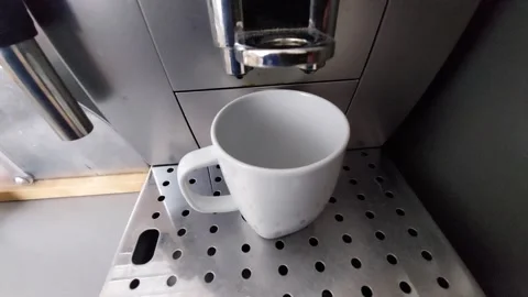 Automatic coffee maker brewing fresh espresso into a white cup Stock Footage 333643319