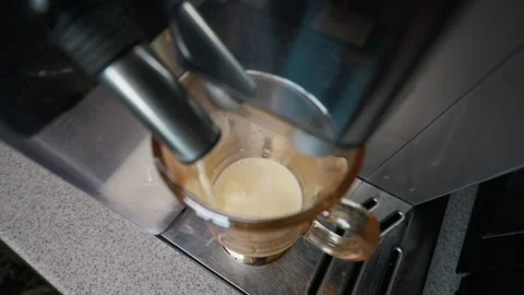 Automatic Coffee Maker Dispensing Hot Frothed Milk Into Glass Mug Video stock 339180371