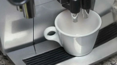An automatic coffee maker prepares a coffee drink and pours it into a cup. Video stock 95562202