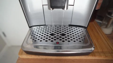 An automatic coffee maker prepares a coffee drink and pours it into a cup. Stock Footage 273403684