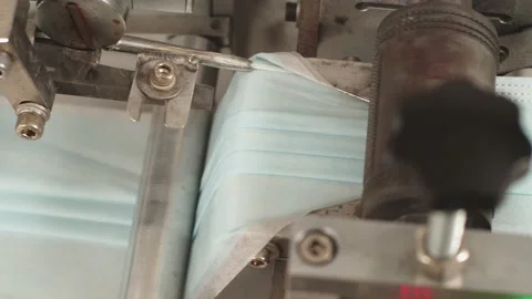 Automatic collection of non-woven face mask from parts. Installation of rigid Stock Footage 204038596