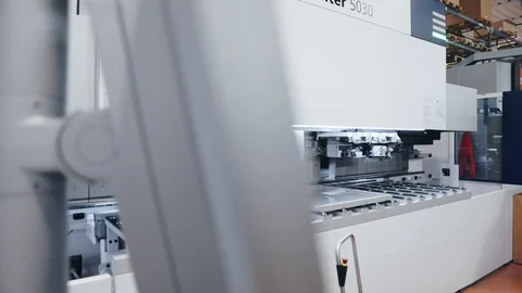 Automatic computerized cnc machine bending sheet metal products in factory Stock Footage 125965662