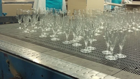 Automatic conveyor line or belt with rows of transparent crystal drink glasses  Stock Footage 121308819