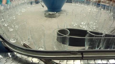 Automatic conveyor line or belt with rows of transparent crystal drink glasses i Stock Footage 121309599