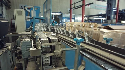 Automatic conveyor line or belt with rows of transparent crystal drink glasses i Stock-Footage 121310610