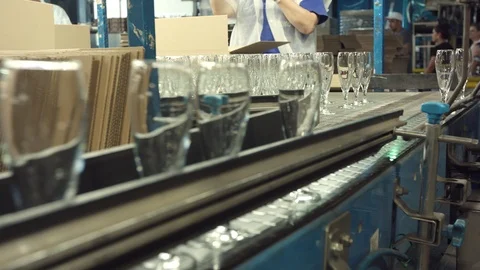 Automatic conveyor line or belt with rows of transparent crystal drink glasses i Stock Footage 121310687
