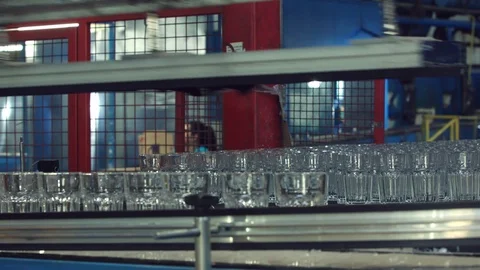 Automatic conveyor line or belt with rows of transparent crystal stemware in ind 스톡 동영상 121360273
