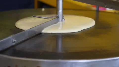 Automatic Crepe Maker Machine Spreading Batter on Hot Griddle Close Up Stock-Footage 345692636