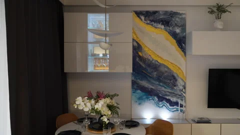Automatic curtains closing beside abstract wall art and hanging cabinet Stock Footage 347874534