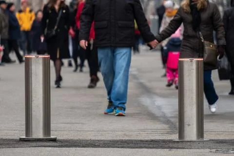 Automatic cylindrical barriers on the pedestrian zone against the background  Stock Photos