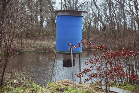Automatic deer feeder in the autumn forest in Denmark Stock Photos