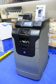 Automatic deposit machine Glory placed on a stand. Stock Photos