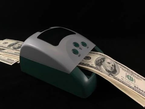 Automatic detector for checking banknotes. Dollars are checked through the de Stock Photos