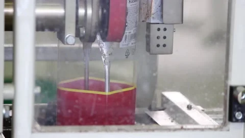 Automatic device drops candy in transparent packaging Stock Footage 128643212