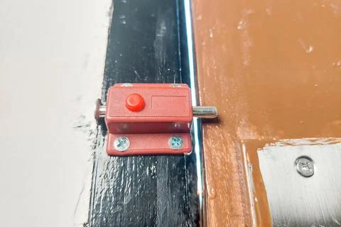 This automatic door bolt with a red button serves as a convenient spring-lo.. Stock Photos