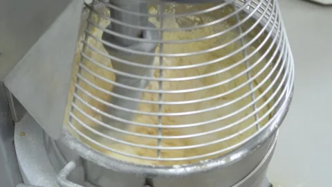 Automatic Dough Kneading Process in Professional Bakery Machine Stockbeeldmateriaal 333996566