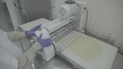 Automatic dough pressing machine in food production facility. Stock-Footage 330239948