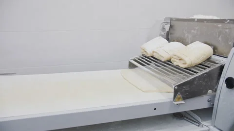 Automatic Dough Sheeter on Conveyor for Bakery Production Stock Footage 321132584