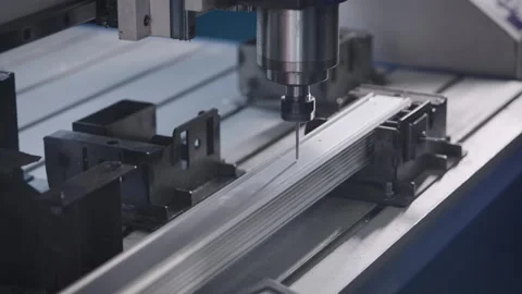 Automatic drilling machine with CNC control. The process of creating holes in a Stock Footage 240905567