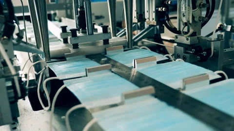 Automatic earloop attaching machine at a face mask production factory Video stock 142139429