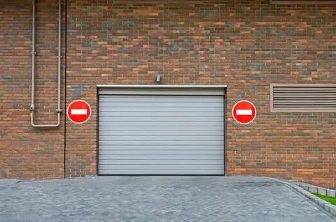 Automatic electric roll-up garage gate for departure Stock Photos