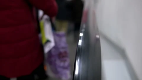 Automatic escalator in a mall, a crowd of people coming down Stock Footage 145002955