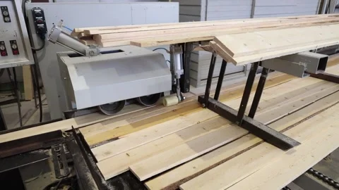 Automatic feeding of boards into a woodworking machine at a factory Stock Footage 319428666
