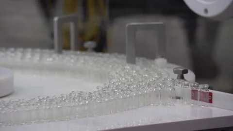 Automatic filling and sealing machine for glass ampoules 库存影片 99084224